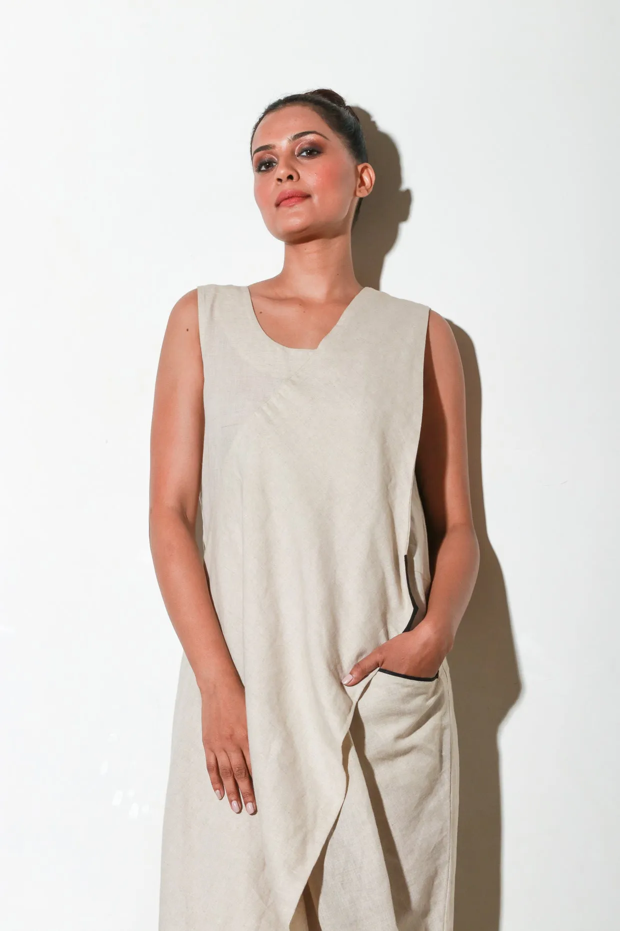 Ecru asymmetric sleeveless jumpsuits.